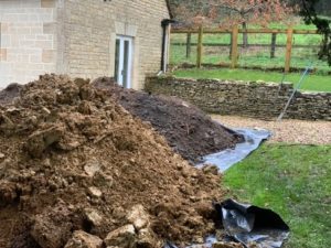 Piles of soil on plastic to protect the surfaces