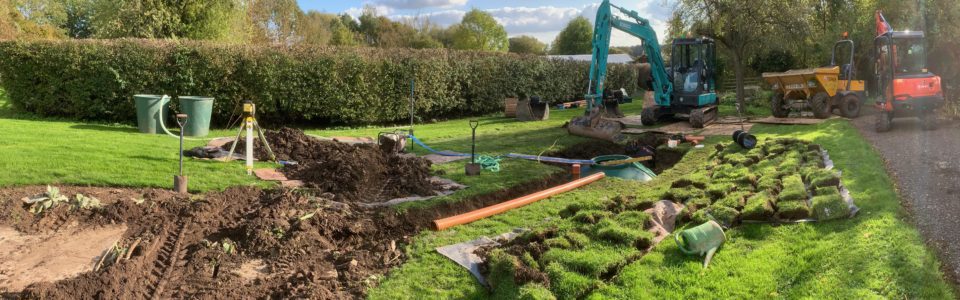 digger and dumper in garden and tank in the ground