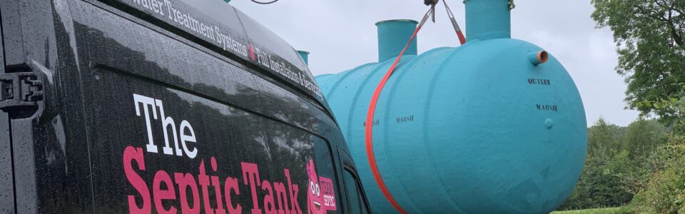 Branded van and blue sewage treatment plant